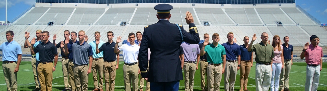 Students in formation taking pledge from military officer