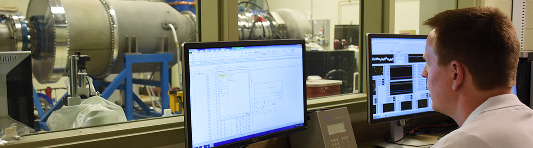 student working in lab control room