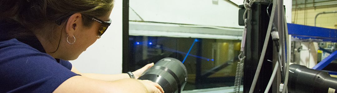 student in the lab with a laser