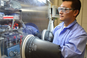 Zhaoxin Yu, postdoctoral researcher in mechanical and nuclear engineering, puts together the components of a battery.