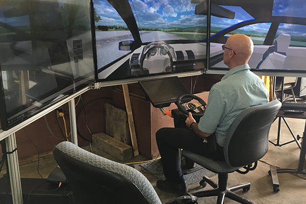 Denny Kovalick, test track manager for The Larson Transportation Institute, takes the highway driving simulator for a test drive before the 2017 Pennsylvania Automated Vehicle Summit.