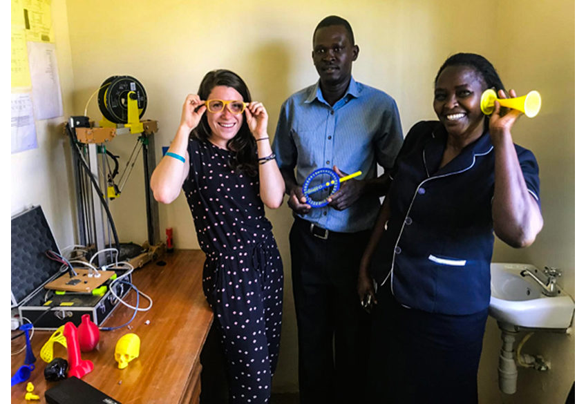   Alenna Beroza, Kijenzi engineer, shows off some Kijenzi parts designed with and for nurse/administrator Jennifer Simani and biomedical engineer Daniel Obego. Alenna has spent the last four months working in Kombewa District Hospital, co-developing and testing parts with local professionals and Kijenzi engineers in the US.