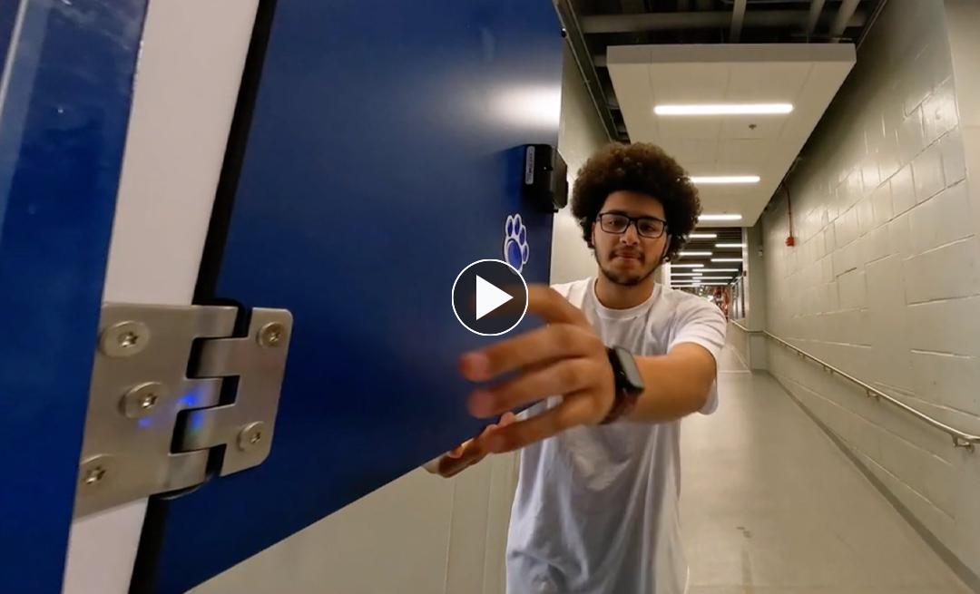 A person holds a locker door open