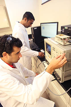 Students working at a research station in the EMCLab